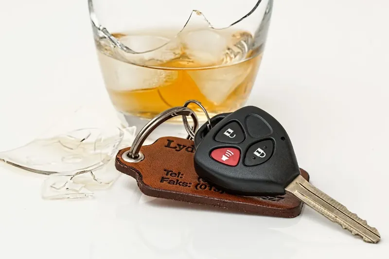 alcohol in a broken glass next to a set of car keys