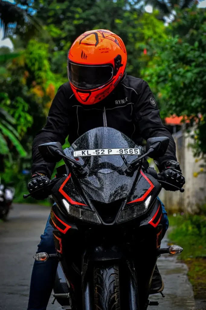 a human with a biker helmet on a motorcycle