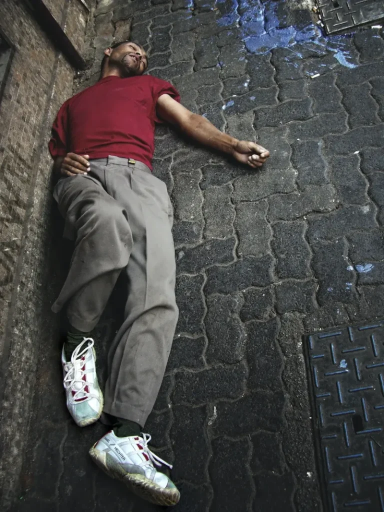 man sleeping outside on the ground