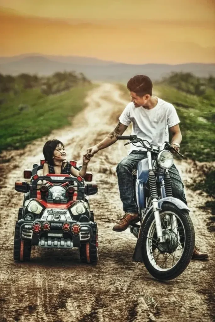 man on a motorcycle fist bumping his daughter