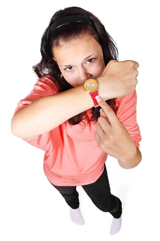 woman pointing at her watch