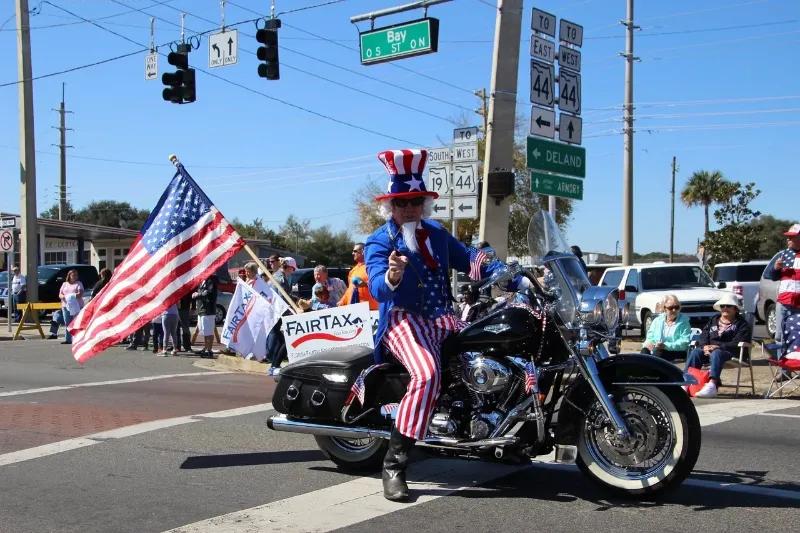 man posing as Uncle Sam on a motorcycle