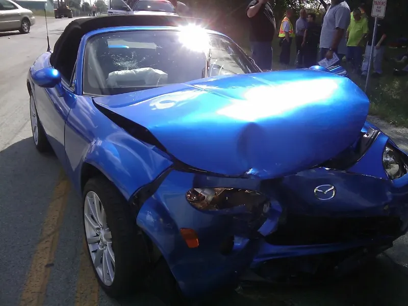 Blue car that has been in a car accident