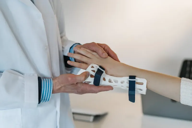 doctor putting on a wrist brace on patient