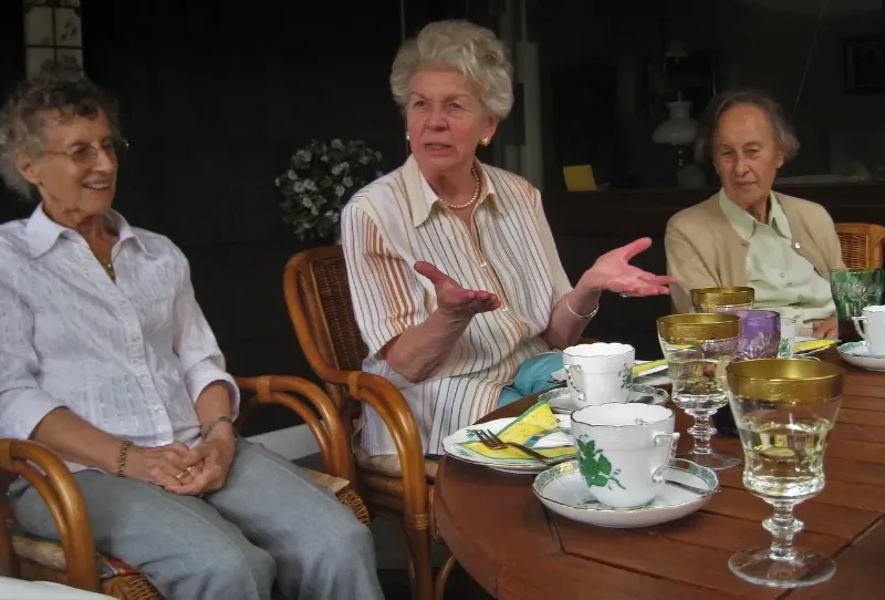 3 women socializing at a table