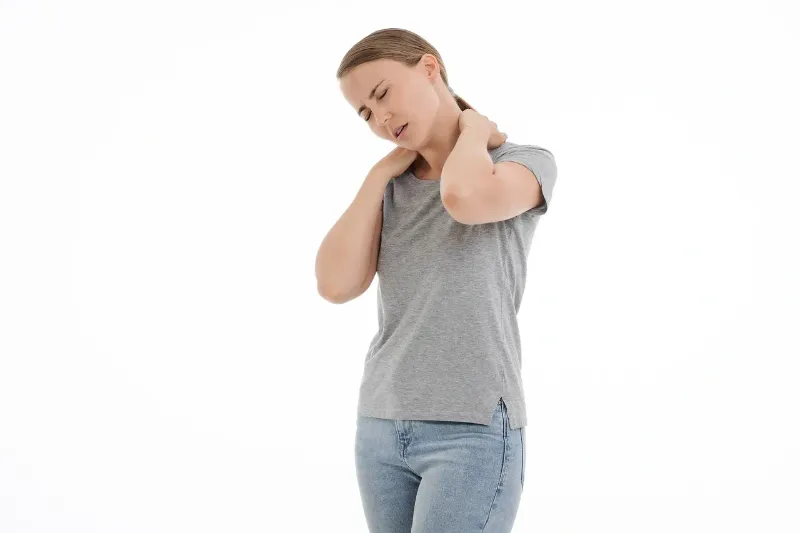 woman rubbing her neck due to neck pain